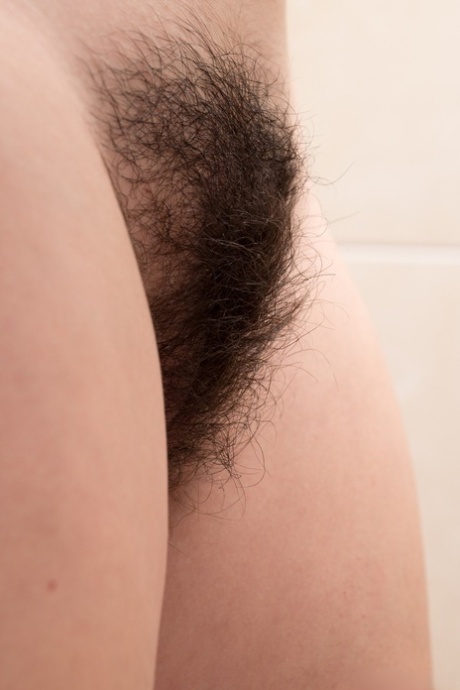 Brunette teen Amber slowly strips and teases her naturals and fingers bush