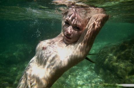 Erotic babe Firebird A stripping lace tights & showing bald twat underwater - pornpics.de