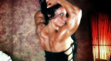 Dark-haired bodybuilder Debbie Bramwell flexes her muscles during a SFW gig