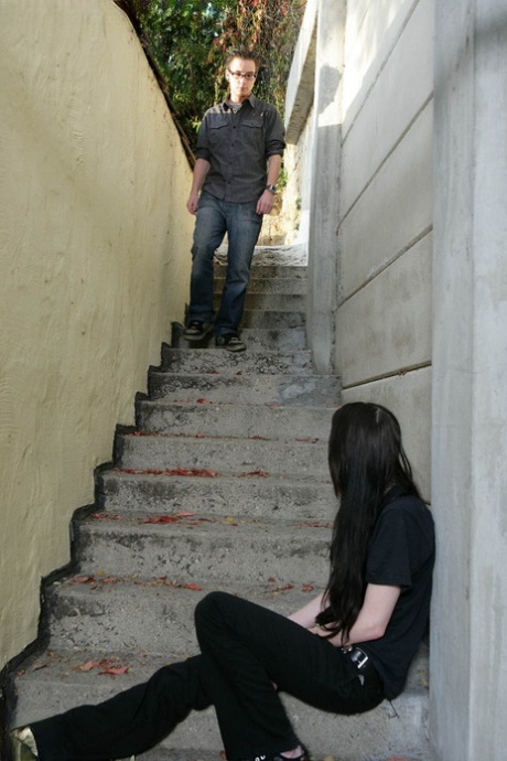 Brunette teen smokes in a stairwell prior to giving a blowjob