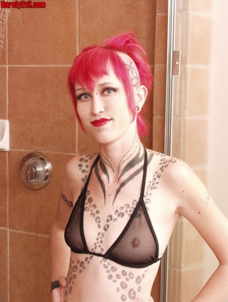 Tattooed alt girl Jax sports dyed hair and a phat ass while taking a shower
