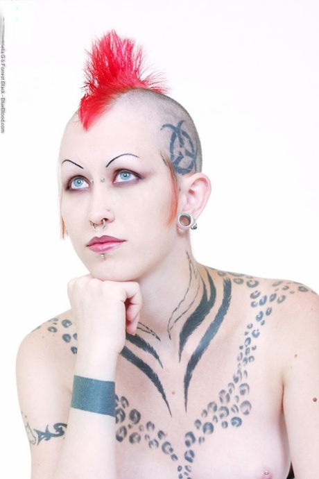 Alt model Jax wears a waist cincher while toying her bald pussy in latex boots