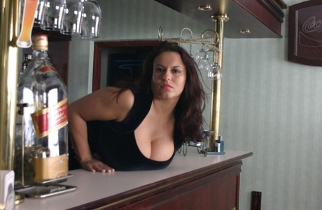 Brunette bartender Aneta Buena sets her giant breasts free while at work - pornpics.de