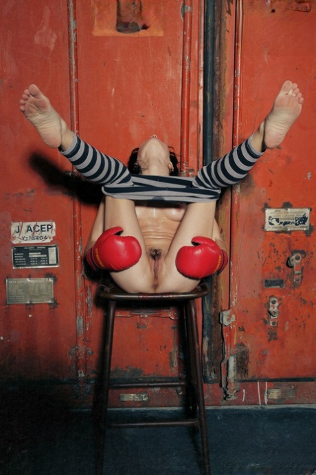 Young brunette Night A doffs striped leggings to pose nude in boxing gloves - pornpics.de