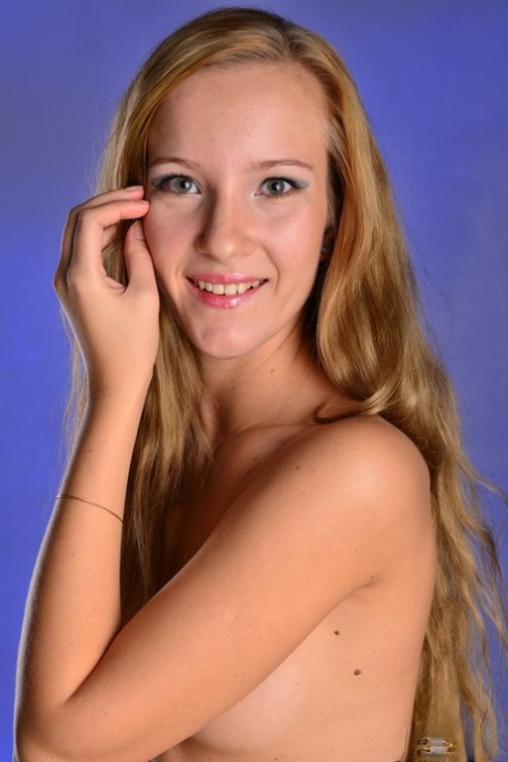 Barely legal girl Hannah J slips out of a dress to pose nude in high heels