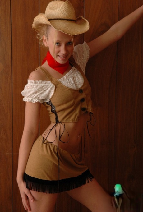 Cute blonde girl with blue eyes flashes her bare ass in cowgirl attire - pornpics.de