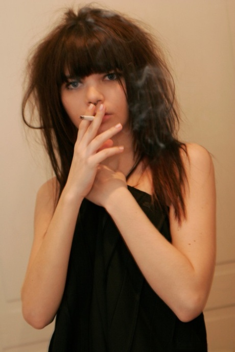 Petite girl Kaira 18 smokes while getting totally naked behind a closed door - pornpics.de
