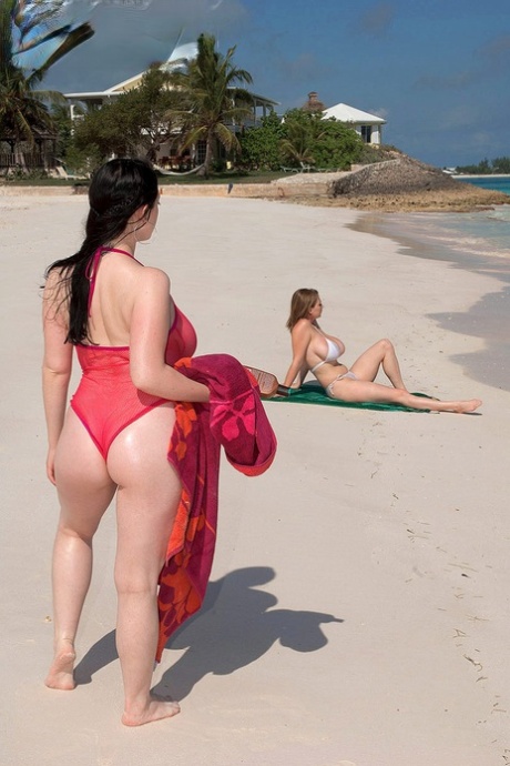 Busty lesbian girls let their huge knockers loose to kiss & lick on the beach