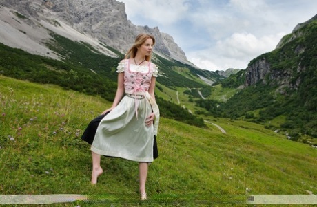 Hot mountain maiden Belinda loses long dress to enjoy a breeze on her big tits