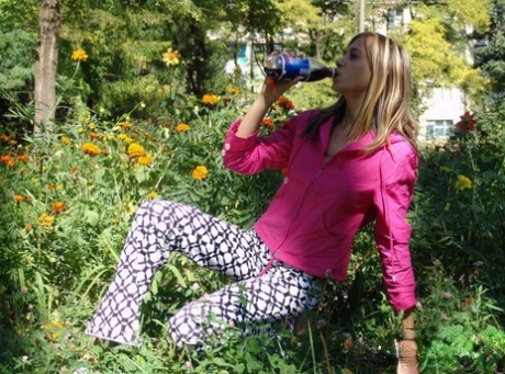 Young blonde flashes her tits and ass while out in public places