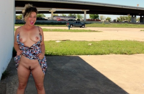 Naughty housewife June Larue goes for a walk in public with butt plug in ass - pornpics.de