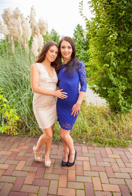 Brunette lesbians Angelik and Tiffany model dresses prior to anal play