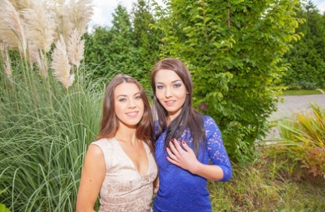 Brunette lesbians Angelik and Tiffany model dresses prior to anal play