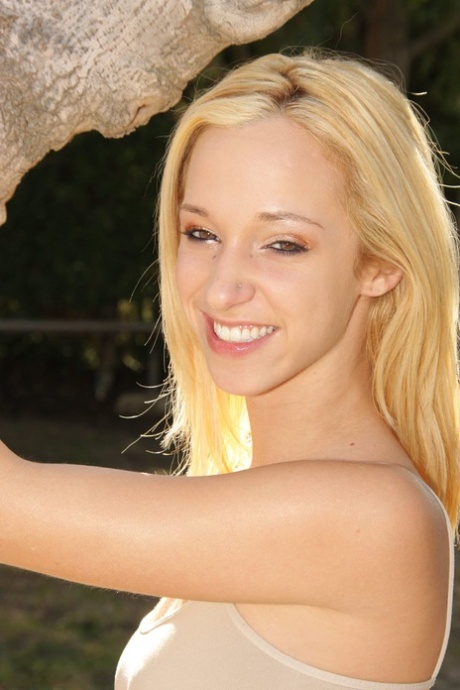 Natural blonde Jada Stevens flaunts her hot ass as she disrobes by a tree