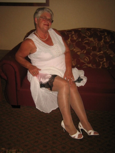Old amateur Girdle Goddess lets her boobs loose while on a chesterfield