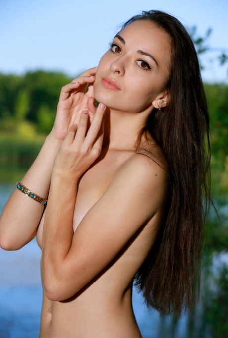 Sweet teen Chanel C gets completely naked on a riverbank during the day