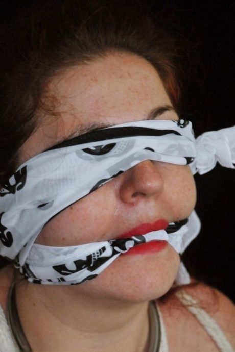 Fat female with red lisp is left gagged and tied up by ropes