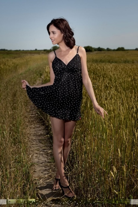 Petite brunette teen Sabrina G wanders naked in a farmer's field