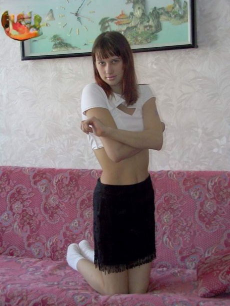 Redhead amateur poses nude for the first time in white socks on a couch