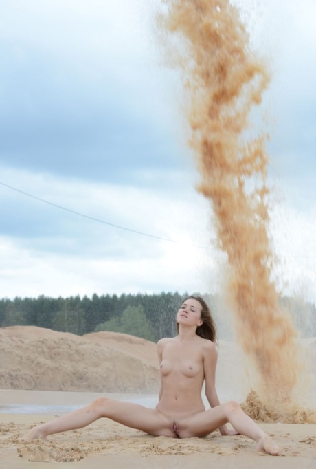 Teen amateur Rumba narrowly misses being sand blasted while doffing a bikini