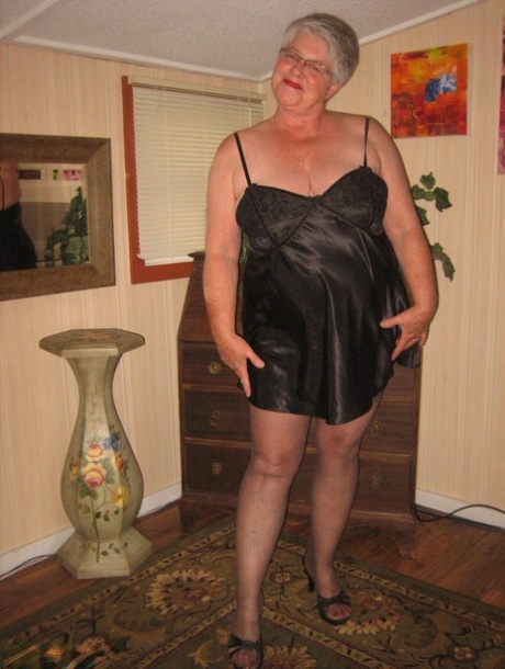 Fat old woman Girdle Goddess doffs black lingerie to pose nude in stockings