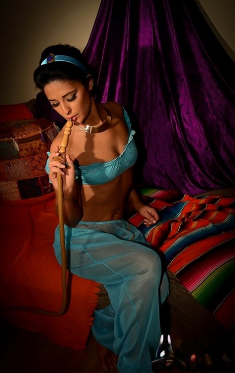 Solo girl Nicola Kiss puffs on a hookah pipe while masturbating in a tent