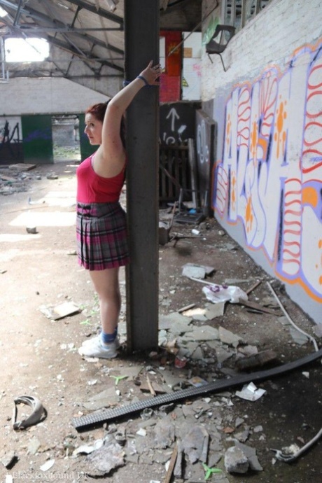 Chubby redhead is fitted with a ball gag and tied to a post and that