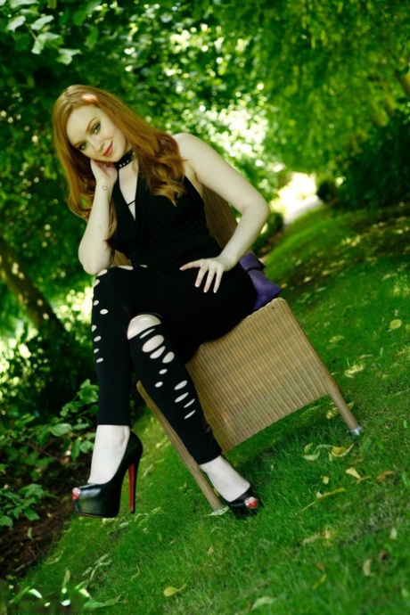 Gorgeous redhead Kloe Kane strips to her heels in an English garden