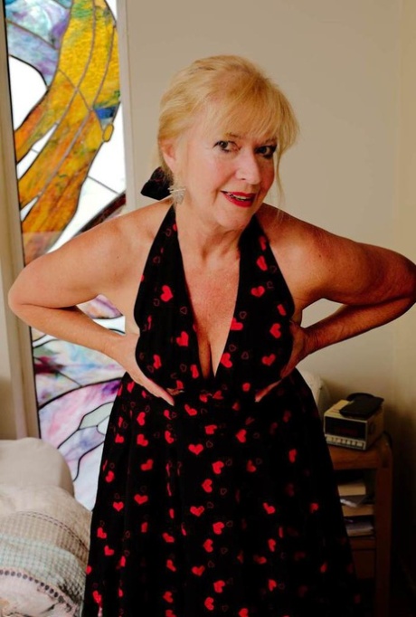 Blonde granny Veronique takes off heels and panties before masturbating