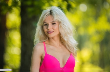 Platinum blond teen Zarina A doffs pink bra and panty set to pose nude in tent