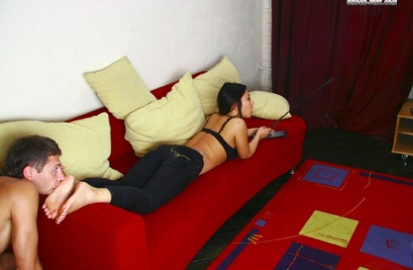Asian chick has a male Caucasian slave worship her bare feet