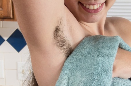 Solo girl with unshaven armpits fingers her wet beaver in kitchen sink