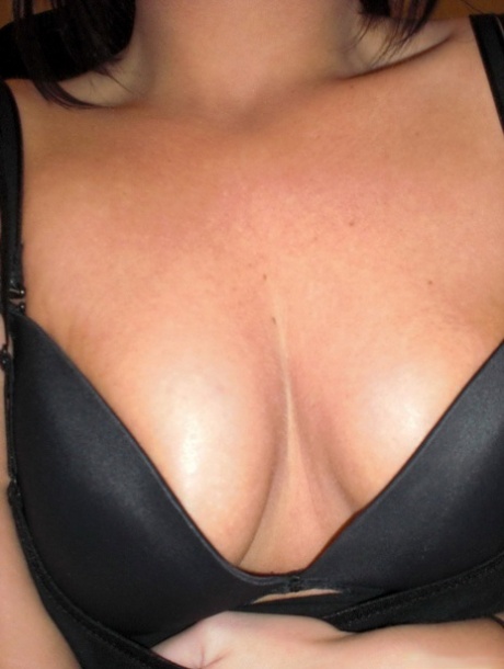 Caucasian teen takes off a black bra while wearing sexy black underwear
