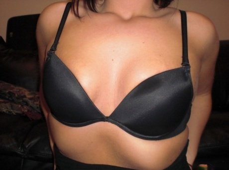 Caucasian teen takes off a black bra while wearing sexy black underwear