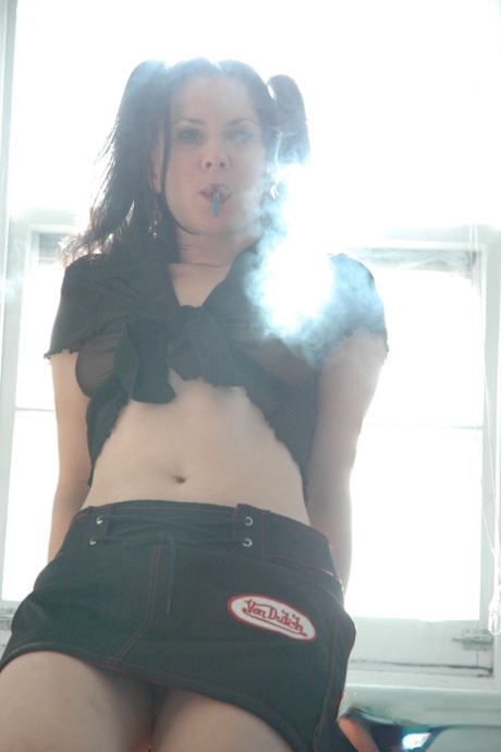 Solo girl Mina smokes while masturbating her shaved pussy on a stool - pornpics.de