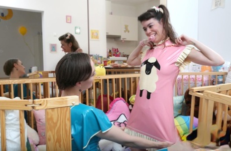 Diaper loving female is attended to by her latex attired lesbian lover