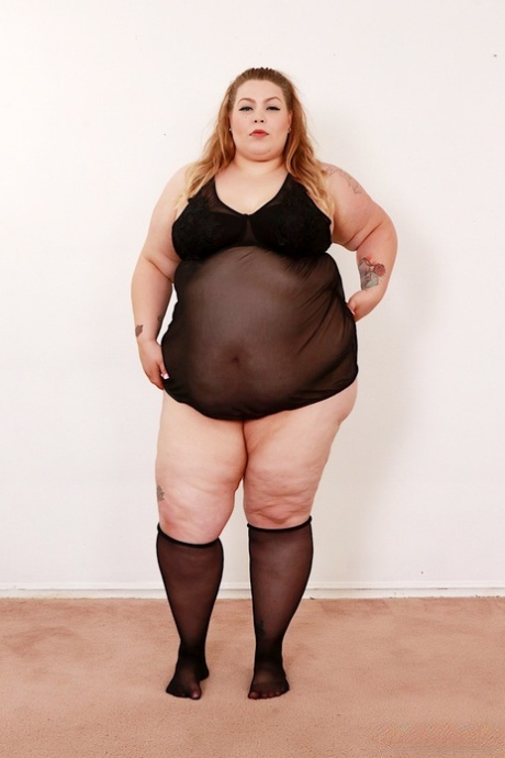Super-sized BBW Baby Doll gets naked on a futon in knee-high nylons