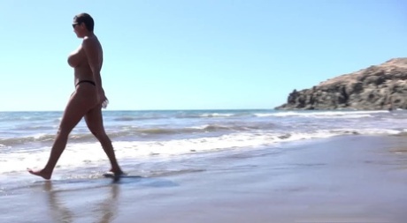 Big titted woman Chloe Lamour squats for a pee while walking on a beach - pornpics.de