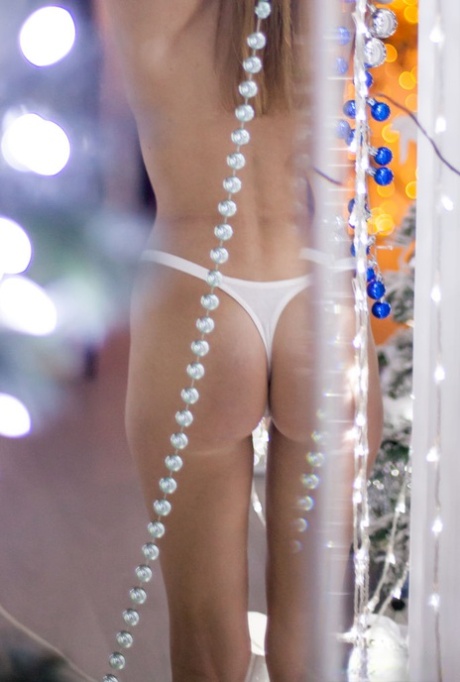 Barely legal girl Candy N gets totally naked amid Christmas lights - pornpics.de
