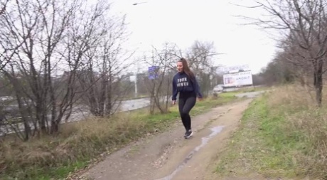 Brunette teen Nicolette Noir takes a badly needed piss on a dirt path