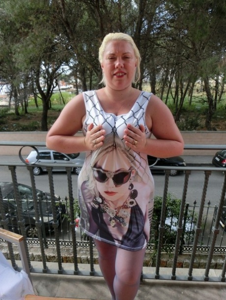 Older plumper Barby gets naked on her balcony as cars pass by below