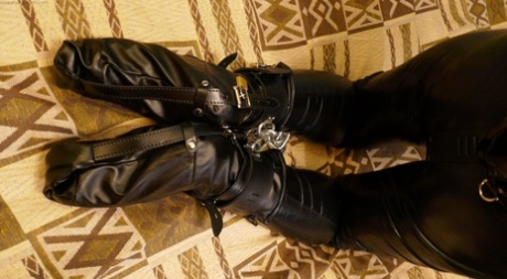 Amateur model works clear of cuffs in leather clothing and a mask