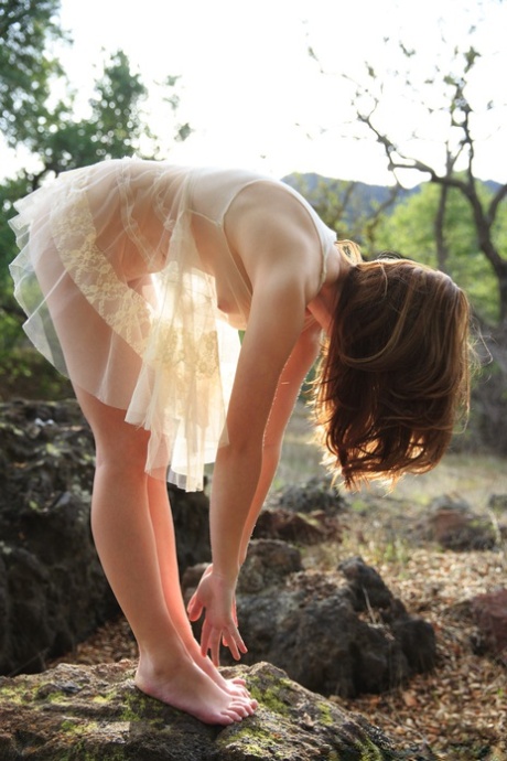 First timer models a see-through dress while barefoot in nature