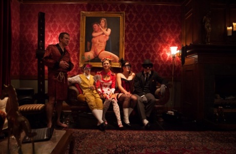 Black and white female sex slaves perform during a kinky adult party