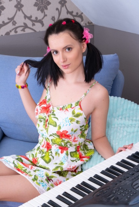 Young looking girl Minnie gets naked in pigtails while playing a keyboard - pornpics.de