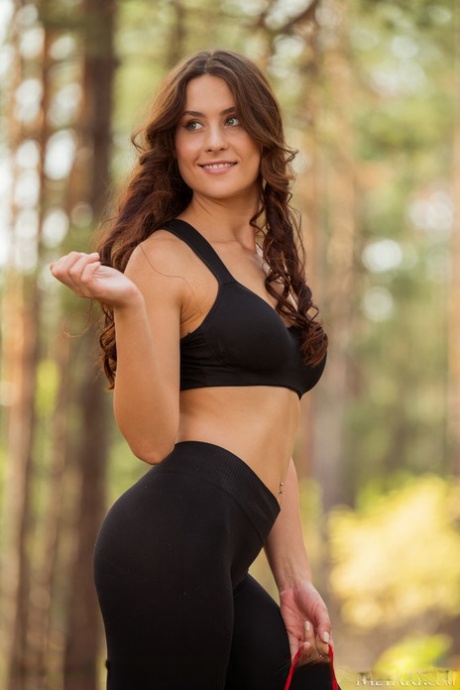 Sweet teen Mara Blake removes spandex attire on a yoga mat in a forest - pornpics.de