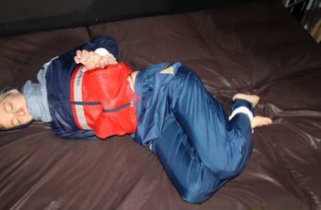 Caucasian amateur Sonja is tied up while wearing nylon rain gear