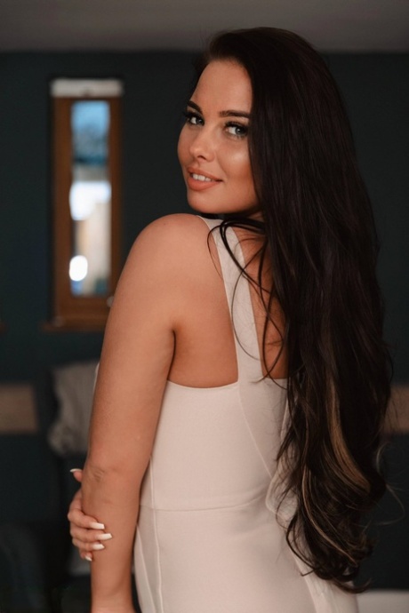 British beauty Kym Graham slips off a tight dress to pose nude