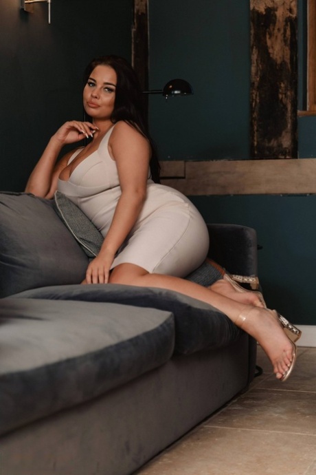 British beauty Kym Graham slips off a tight dress to pose nude