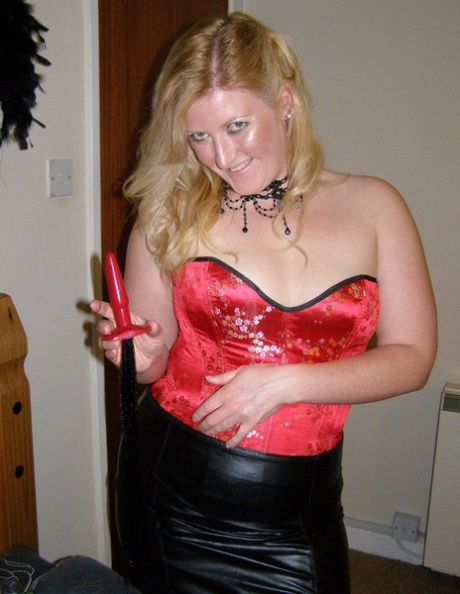 Strawberry blonde Samantha inserts a butt plug while wearing mesh nylons
